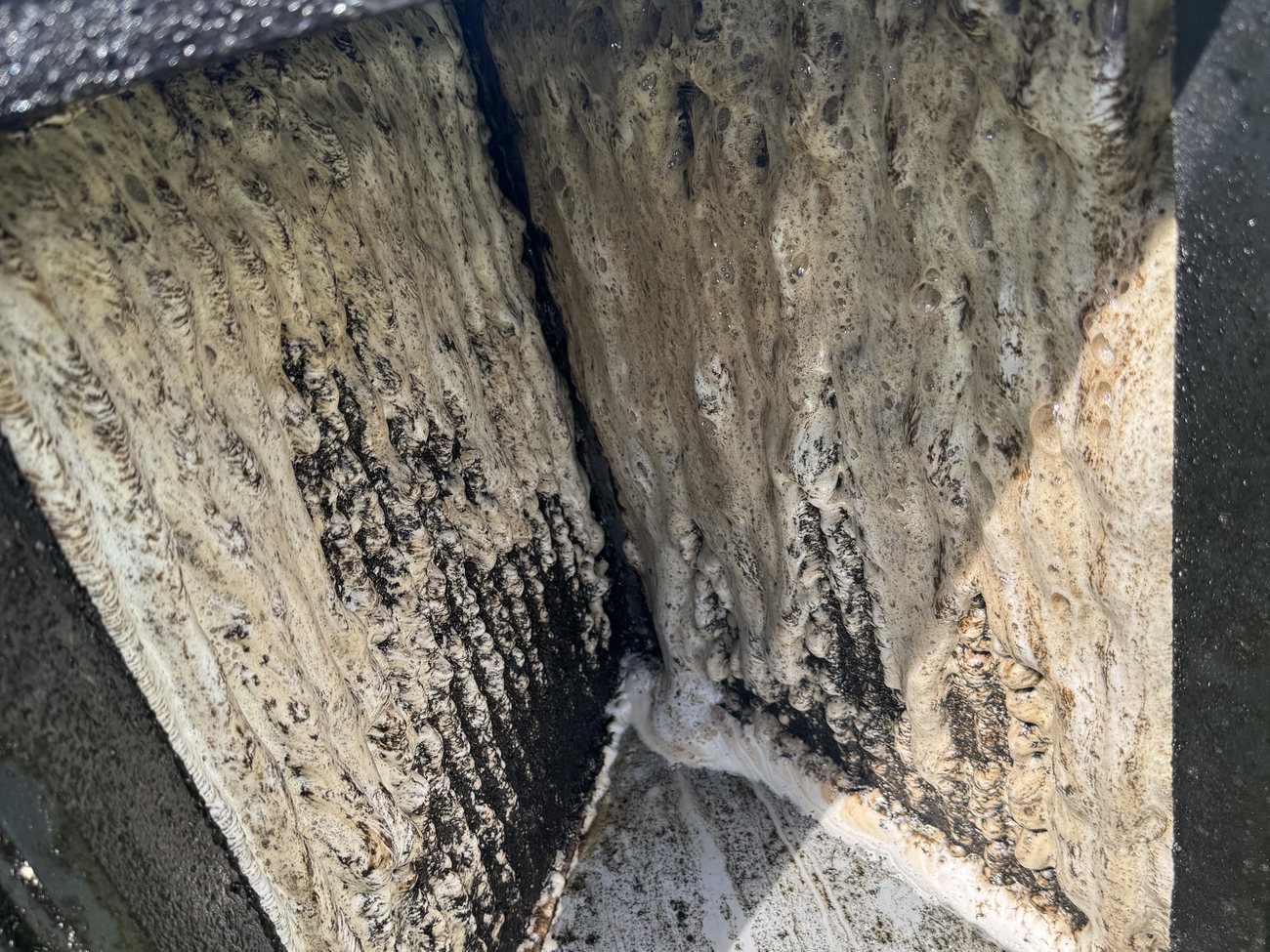 Condenser coil before cleaning, clogged with debris